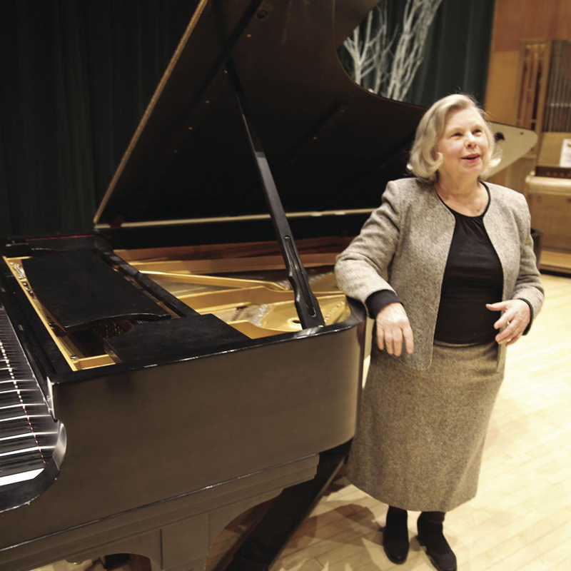 Barbara Blegen stands at piano